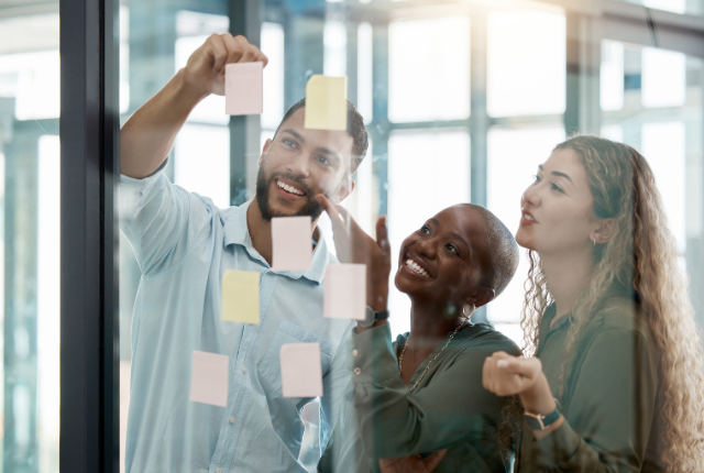 Photo of people looking at white board